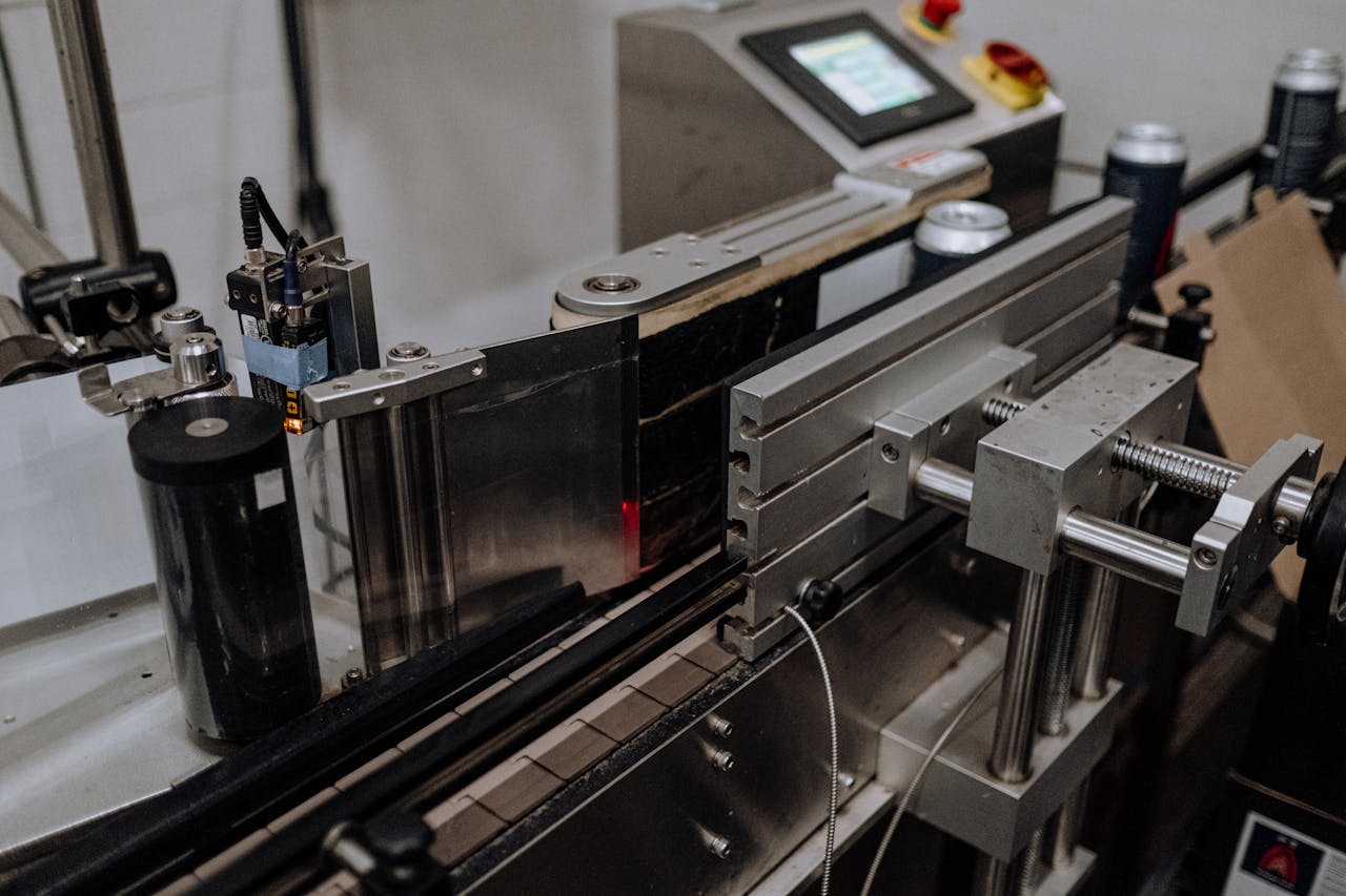 Offerings Close-up of automated canning equipment in a modern brewery assembly line.
